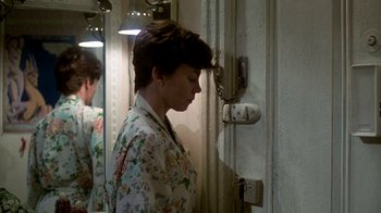 Movie still from “The Goodbye Girl” (1977), directed by Herbert Ross – A woman standing in front of a wall with a phone; Close Up shot, Over the shoulder angle