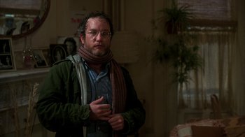 Movie still from “The Goodbye Girl” (1977), directed by Herbert Ross – A man with a beard wearing glasses and a green jacket; Close Up shot, Over the shoulder angle