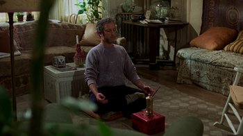 Movie still from “The Goodbye Girl” (1977), directed by Herbert Ross – A man sitting on the ground in a living room; Medium shot, High angle