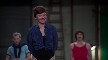 Movie still from “The Goodbye Girl” (1977), directed by Herbert Ross – A woman standing in front of another woman in front of a ladder; Medium shot, Over the shoulder angle