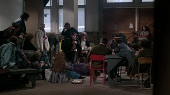 Movie still from “The Goodbye Girl” (1977), directed by Herbert Ross – A group of people sitting and standing around a room; Wide shot, High angle