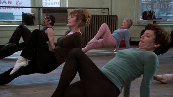 Movie still from “The Goodbye Girl” (1977), directed by Herbert Ross – A group of people doing different poses in a room; Wide shot, High angle