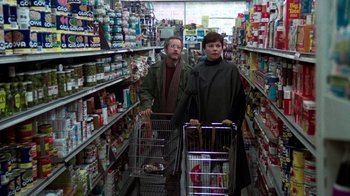 Movie still from “The Goodbye Girl” (1977), directed by Herbert Ross – A man and a woman pushing shopping carts in a store; Medium shot, Low angle