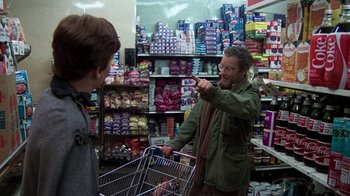 Movie still from “The Goodbye Girl” (1977), directed by Herbert Ross – A man in a grocery store holding a shopping cart; Medium shot, Over the shoulder angle