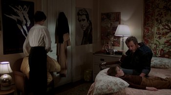 Movie still from “The Goodbye Girl” (1977), directed by Herbert Ross – A man and a woman sitting on a bed in a room; Wide shot, Over the shoulder angle