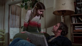 Movie still from “The Goodbye Girl” (1977), directed by Herbert Ross – A man laying on the ground looking at a girl; Medium shot, Over the shoulder angle