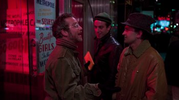 Movie still from “The Goodbye Girl” (1977), directed by Herbert Ross – A group of men standing next to each other on a street; Medium shot, Over the shoulder angle