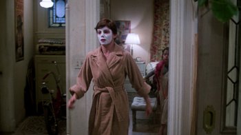 Movie still from “The Goodbye Girl” (1977), directed by Herbert Ross – A woman dressed as a mime is walking through a doorway; Medium shot, Over the shoulder angle
