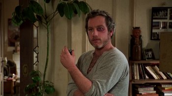 Movie still from “The Goodbye Girl” (1977), directed by Herbert Ross – A man holding a cigarette in his hand; Medium shot, Low angle