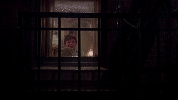 Movie still from “The Goodbye Girl” (1977), directed by Herbert Ross – A young child looking out of a window at night; Wide shot, High angle