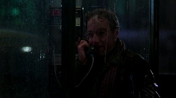 Movie still from “The Goodbye Girl” (1977), directed by Herbert Ross – A man talking on a phone while standing in the rain; Close Up shot, Low angle