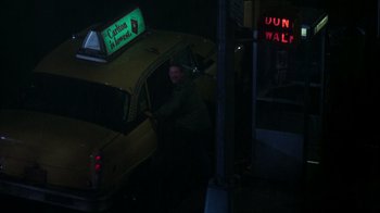 Movie still from “The Goodbye Girl” (1977), directed by Herbert Ross – A man standing in front of a yellow taxi cab at night; Wide shot, High angle