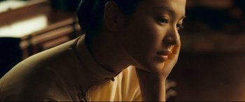 Movie still from “The Grandmaster” (2013), directed by Kar-Wai Wong – A person with his chin resting on his hand; Close Up shot, Over the shoulder angle