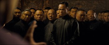 Movie still from “The Grandmaster” (2013), directed by Kar-Wai Wong – A group of men standing next to each other in a room; Medium shot, Over the shoulder angle