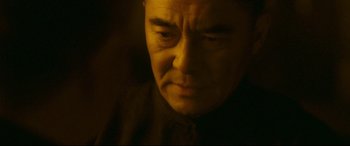 Movie still from “The Grandmaster” (2013), directed by Kar-Wai Wong – A man's face in the dark; Close Up shot, Low angle