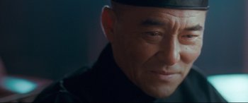 Movie still from “The Grandmaster” (2013), directed by Kar-Wai Wong – An older man with a black hat is looking at the camera; Close Up shot, Over the shoulder angle
