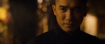 Movie still from “The Grandmaster” (2013), directed by Kar-Wai Wong – A person wearing a black shirt; Close Up shot, Low angle