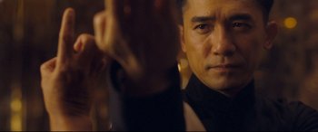 Movie still from “The Grandmaster” (2013), directed by Kar-Wai Wong – A man's face in a mirror; Close Up shot, Over the shoulder angle
