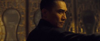 Movie still from “The Grandmaster” (2013), directed by Kar-Wai Wong – A person wearing a black jacket; Close Up shot, Low angle