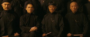 Movie still from “The Grandmaster” (2013), directed by Kar-Wai Wong – A group of men in black shirts and black hats; Medium shot, Low angle