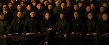 Movie still from “The Grandmaster” (2013), directed by Kar-Wai Wong – A group of men in black shirts and black hats; Wide shot, High angle