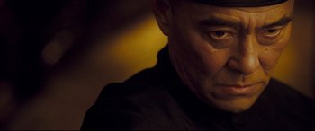 Movie still from “The Grandmaster” (2013), directed by Kar-Wai Wong – A man's face in the dark; Close Up shot, Low angle