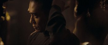 Movie still from “The Grandmaster” (2013), directed by Kar-Wai Wong – A person wearing a hooded sweatshirt; Close Up shot, Over the shoulder angle