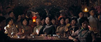 Movie still from “The Grandmaster” (2013), directed by Kar-Wai Wong – A group of people sitting around a table; Medium shot, Over the shoulder angle