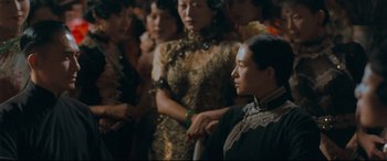 Movie still from “The Grandmaster” (2013), directed by Kar-Wai Wong – A group of women standing around each other; Medium shot, Over the shoulder angle