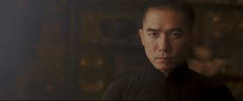 Movie still from “The Grandmaster” (2013), directed by Kar-Wai Wong – A person wearing a black shirt; Close Up shot, Low angle