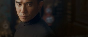 Movie still from “The Grandmaster” (2013), directed by Kar-Wai Wong – A man's face in a dark room; Close Up shot, Low angle