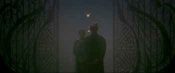 Movie still from “The Grandmaster” (2013), directed by Kar-Wai Wong – A man and a woman standing next to each other in front of lights; Wide shot, Low angle