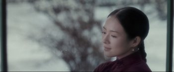 Movie still from “The Grandmaster” (2013), directed by Kar-Wai Wong – A young woman looking out of a window at a tree; Close Up shot, Over the shoulder angle