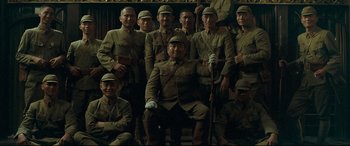 Movie still from “The Grandmaster” (2013), directed by Kar-Wai Wong – A group of men in uniform posing for a picture; Wide shot, Low angle