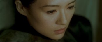 Movie still from “The Grandmaster” (2013), directed by Kar-Wai Wong – A woman's face with brown eyes; Close Up shot, High angle