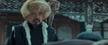 Movie still from “The Grandmaster” (2013), directed by Kar-Wai Wong – A man and a monkey in the snow; Close Up shot, Low angle