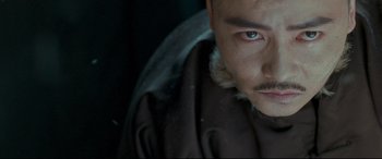 Movie still from “The Grandmaster” (2013), directed by Kar-Wai Wong – A person wearing a coat; Close Up shot, Over the shoulder angle