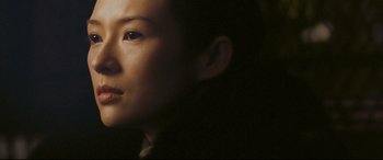 Movie still from “The Grandmaster” (2013), directed by Kar-Wai Wong – A woman's face in the dark; Close Up shot, Low angle