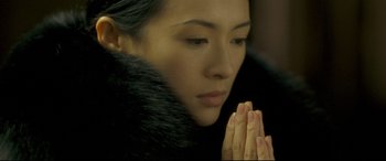 Movie still from “The Grandmaster” (2013), directed by Kar-Wai Wong – A person with their hands clasped in prayer; Close Up shot, High angle