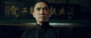 Movie still from “The Grandmaster” (2013), directed by Kar-Wai Wong – A person wearing a black shirt; Close Up shot, Low angle