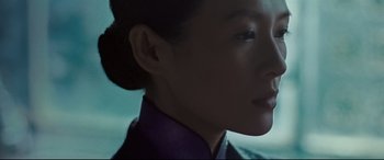 Movie still from “The Grandmaster” (2013), directed by Kar-Wai Wong – A woman's face in a purple shirt; Close Up shot, Low angle
