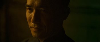 Movie still from “The Grandmaster” (2013), directed by Kar-Wai Wong – A man's face in the dark; Close Up shot, Low angle