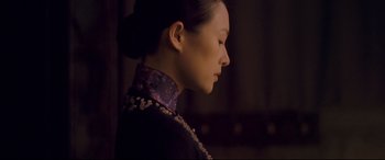 Movie still from “The Grandmaster” (2013), directed by Kar-Wai Wong – A woman wearing a purple neck tie looking to the side; Close Up shot, Low angle