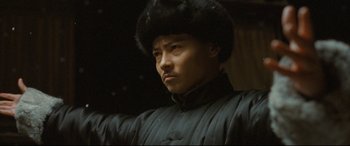Movie still from “The Grandmaster” (2013), directed by Kar-Wai Wong – A man in a black jacket and a black hat; Close Up shot, Low angle