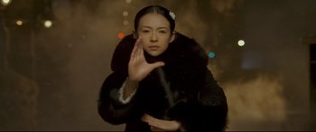 Movie still from “The Grandmaster” (2013), directed by Kar-Wai Wong – A woman in a fur coat holding her hand up to her face; Close Up shot, Over the shoulder angle