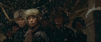 Movie still from “The Grandmaster” (2013), directed by Kar-Wai Wong – A group of people standing next to each other in the snow; Medium shot, Low angle