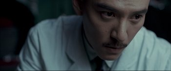 Movie still from “The Grandmaster” (2013), directed by Kar-Wai Wong – A person wearing a white shirt and a tie; Extreme Close Up shot, Low angle