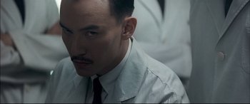 Movie still from “The Grandmaster” (2013), directed by Kar-Wai Wong – A person wearing a suit and tie; Close Up shot, Low angle