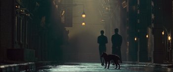 Movie still from “The Grandmaster” (2013), directed by Kar-Wai Wong – Two people and a dog are walking in the dark; Wide shot, Over the shoulder angle