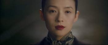 Movie still from “The Grandmaster” (2013), directed by Kar-Wai Wong – A person wearing a dress; Close Up shot, Over the shoulder angle